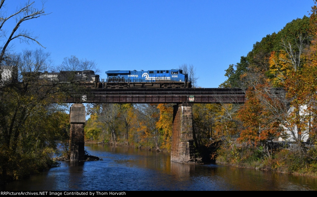 NS's CR heritage unit leads 11J's autoracks east over the Raritan River